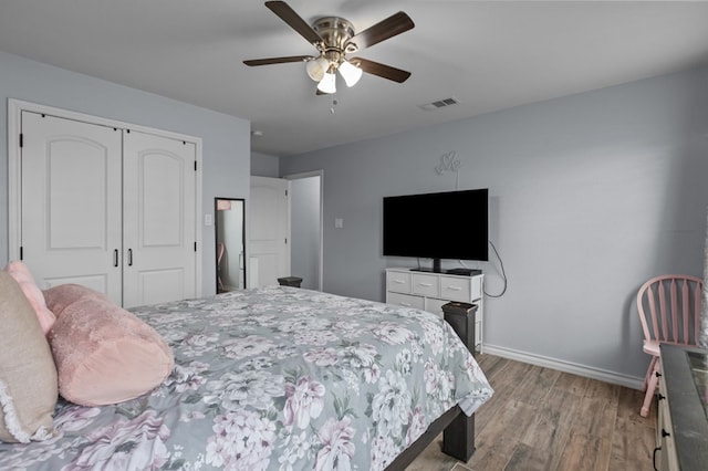 bedroom featuring ceiling fan, a closet, and light hardwood / wood-style flooring