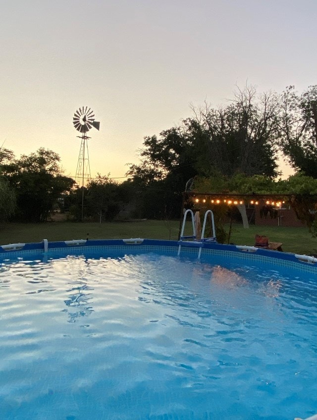 view of pool at dusk