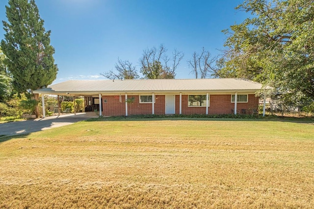 ranch-style house featuring a carport and a front lawn