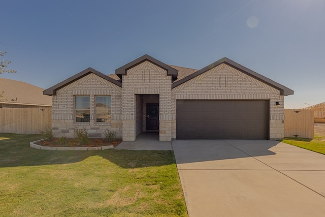 view of front of house featuring a front yard and a garage