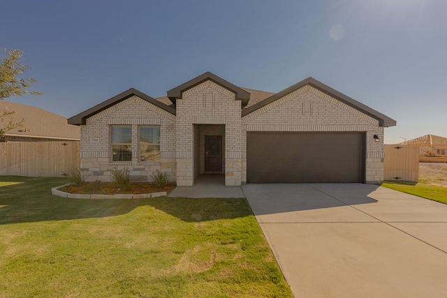 view of front of house with a front yard and a garage