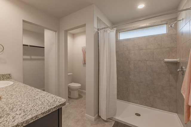 bathroom with tile patterned flooring, a shower with curtain, vanity, and toilet