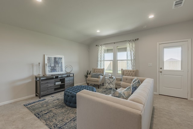 living room featuring plenty of natural light, light tile patterned flooring, and vaulted ceiling