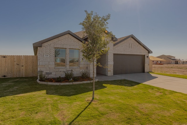 view of front of property with a front lawn and a garage