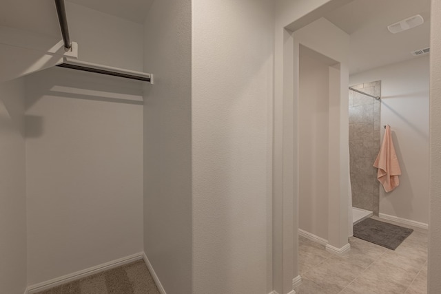 spacious closet with light tile patterned floors