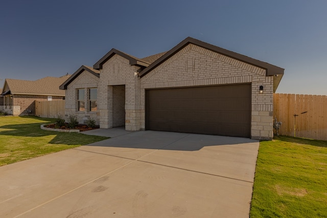 view of front facade with a front yard and a garage