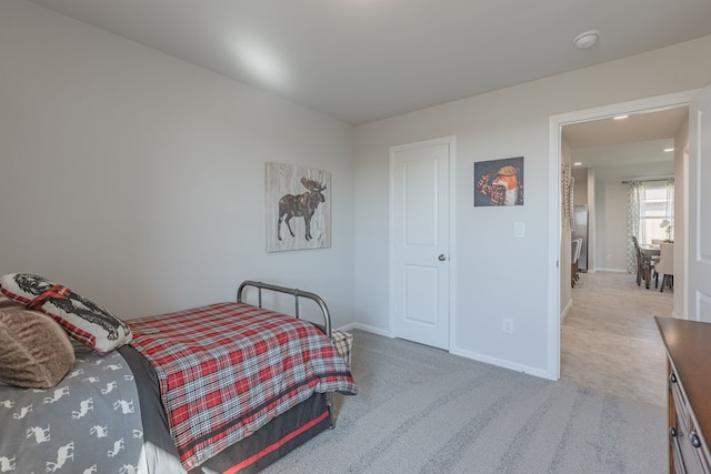 bedroom featuring light colored carpet