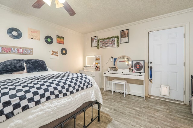 bedroom featuring crown molding, ceiling fan, hardwood / wood-style floors, and a textured ceiling