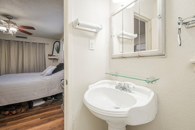 bathroom featuring wood-type flooring, sink, and ceiling fan