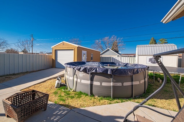 view of yard with an outbuilding and a covered pool