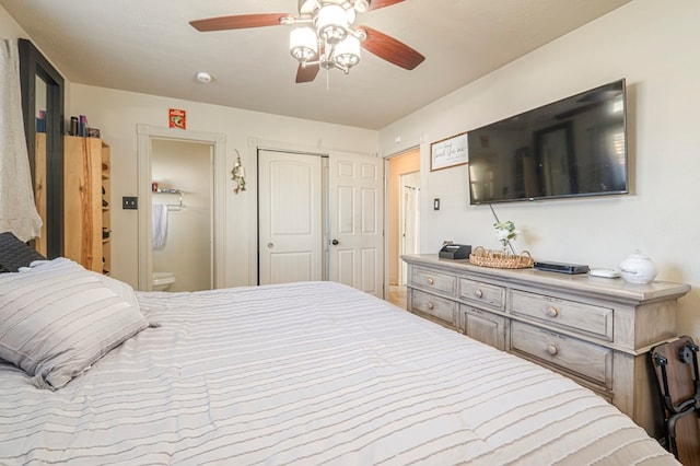 bedroom with ceiling fan, ensuite bath, and a closet