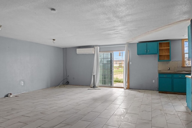 8528 W 24th St, Odessa, TX 79763 - interior space with healthy amount of natural light, a textured ceiling, a wall unit AC, and blue cabinets