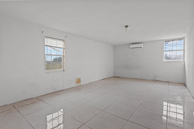 8528 W 24th St, Odessa, TX 79763 - empty room with an AC wall unit and tile patterned flooring