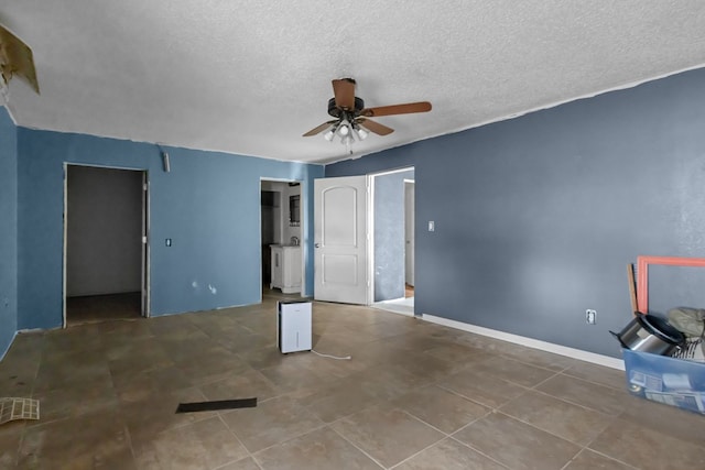 8528 W 24th St, Odessa, TX 79763 - unfurnished bedroom featuring a textured ceiling, ceiling fan, and tile patterned floors