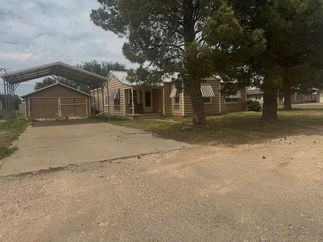 711 24th St, Crane, TX 79731 - manufactured / mobile home with driveway, a detached carport, and an outdoor structure