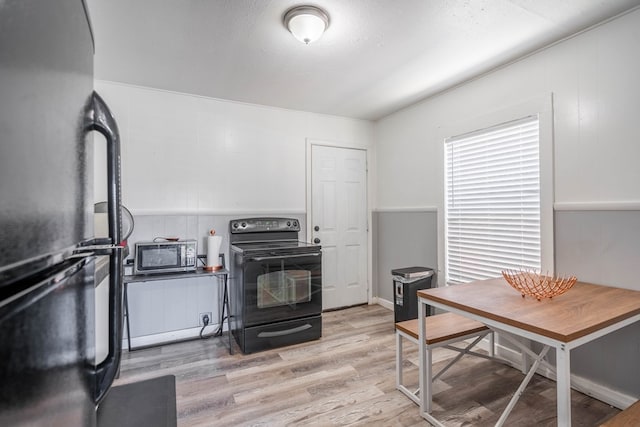 2707 Eisenhower Rd, Odessa, TX 79762 - kitchen featuring black appliances and light wood-type flooring