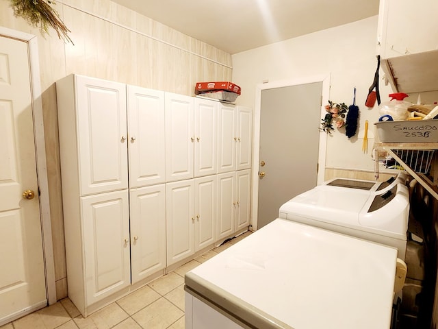 2104 Redbud Ave, Odessa, TX 79761 - laundry room with cabinet space, light tile patterned floors, and washer and dryer