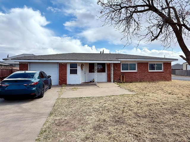 ranch-style home featuring concrete driveway, a garage, fence, and brick siding