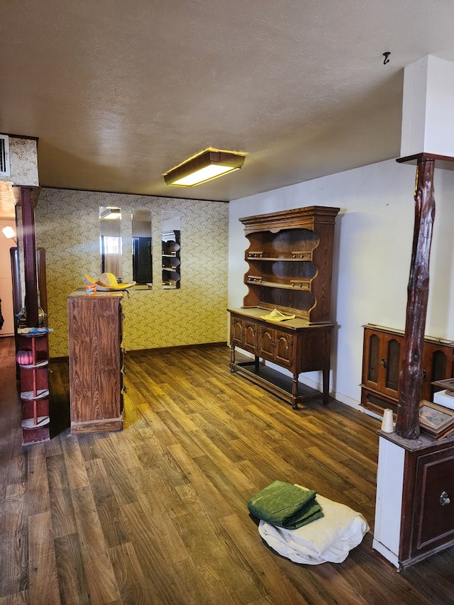 interior space featuring dark hardwood / wood-style floors and a textured ceiling