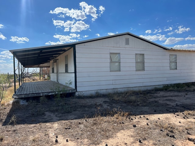 view of home's exterior featuring an attached carport