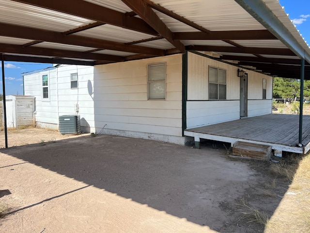 view of side of property with cooling unit and metal roof