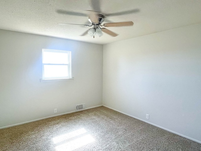 spare room with visible vents, baseboards, a textured ceiling, and a ceiling fan