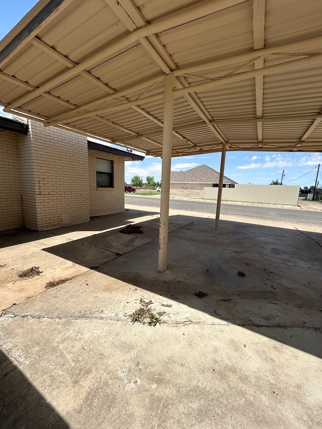 view of vehicle parking with fence