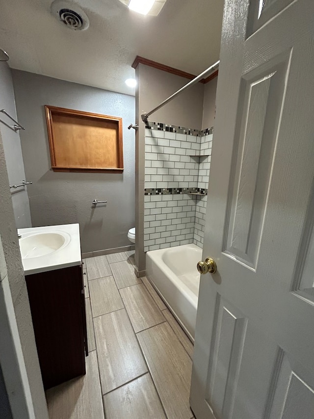 bathroom featuring vanity, toilet, shower / bathing tub combination, wood tiled floor, and visible vents