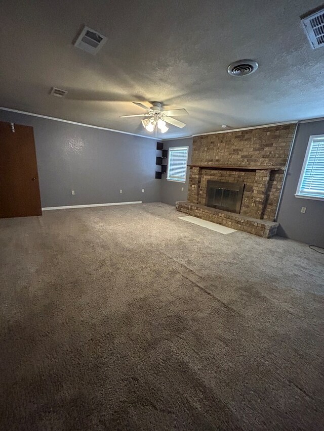 unfurnished living room featuring visible vents, a ceiling fan, carpet, and a brick fireplace