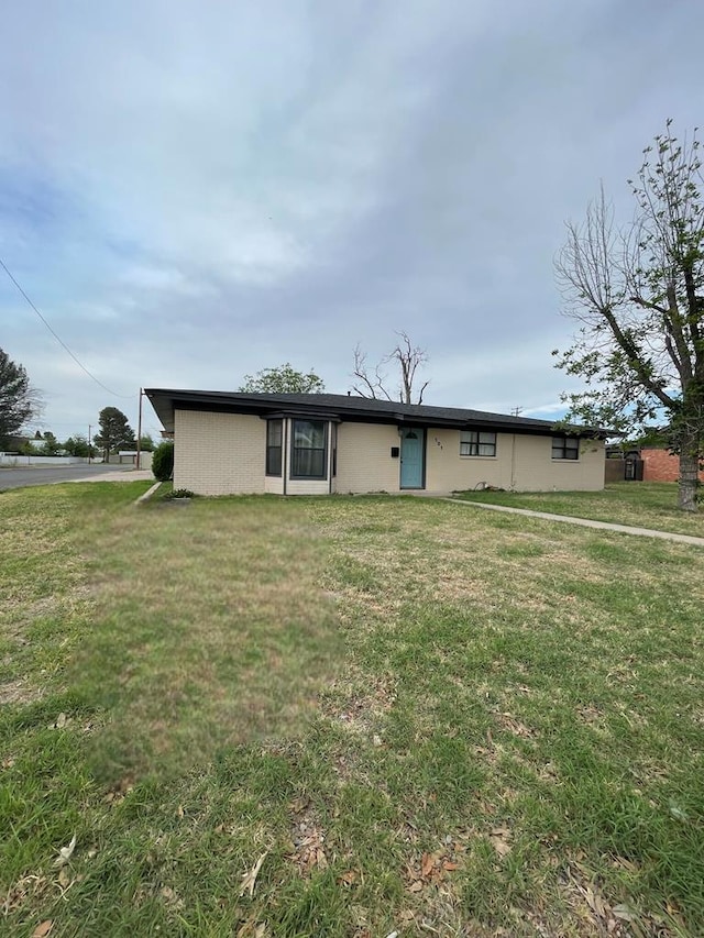 ranch-style house with a front lawn