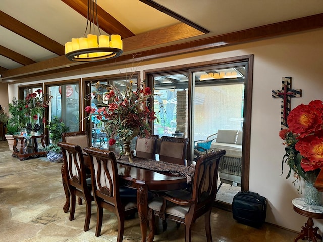 2500 Bainbridge Dr, Odessa, TX 79762 - dining space with stone finish floors, beamed ceiling, and a chandelier