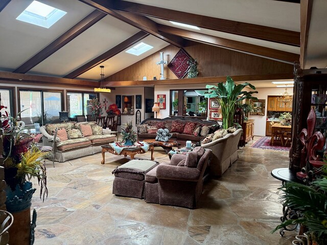 2500 Bainbridge Dr, Odessa, TX 79762 - living room featuring a skylight, stone floors, beam ceiling, and high vaulted ceiling