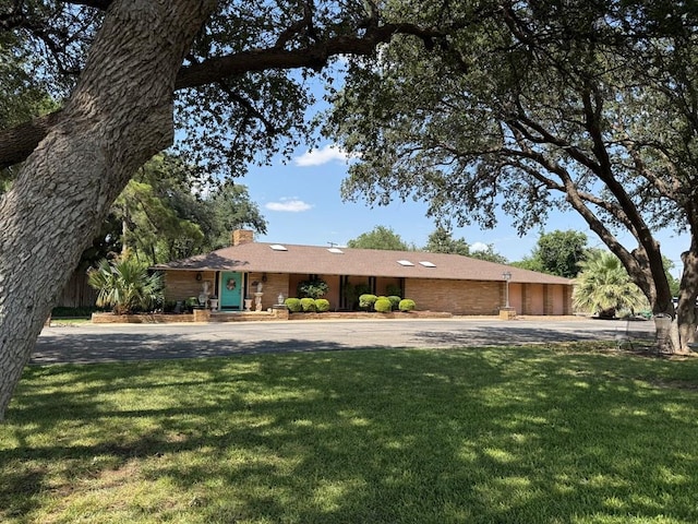 2500 Bainbridge Dr, Odessa, TX 79762 - single story home with a front lawn, a chimney, and asphalt driveway