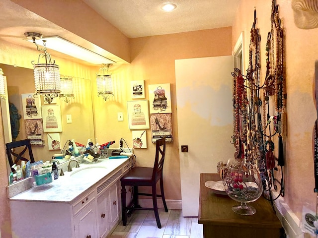 2500 Bainbridge Dr, Odessa, TX 79762 - bathroom featuring vanity and a textured ceiling