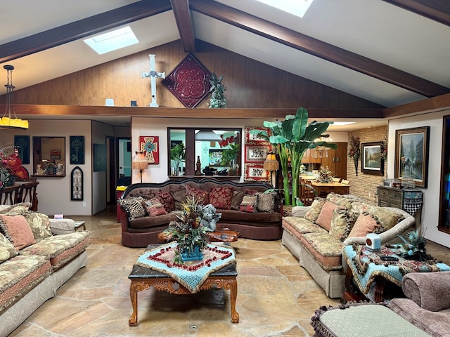 2500 Bainbridge Dr, Odessa, TX 79762 - living room featuring a skylight, beam ceiling, stone finish flooring, high vaulted ceiling, and wood walls