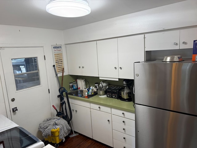 2500 Bainbridge Dr, Odessa, TX 79762 - kitchen featuring freestanding refrigerator, white cabinets, light countertops, and dark wood-type flooring