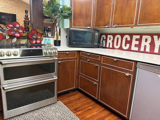 2500 Bainbridge Dr, Odessa, TX 79762 - kitchen featuring stainless steel appliances, light countertops, and dark wood-style flooring