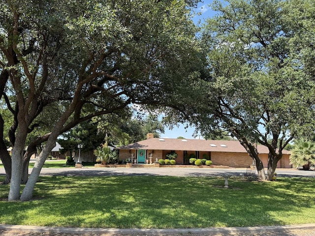 2500 Bainbridge Dr, Odessa, TX 79762 - single story home with a front lawn and a chimney