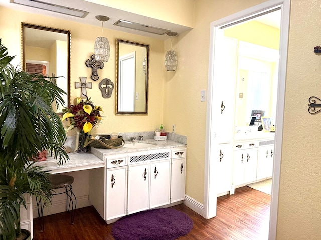 2500 Bainbridge Dr, Odessa, TX 79762 - bathroom featuring wood finished floors, vanity, and a textured wall