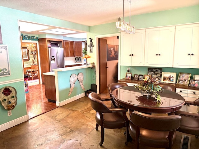 2500 Bainbridge Dr, Odessa, TX 79762 - dining room featuring light stone finish floors and a textured ceiling