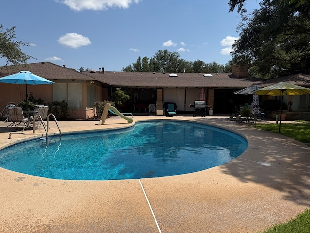 2500 Bainbridge Dr, Odessa, TX 79762 - outdoor pool featuring a patio area, a grill, and a water slide