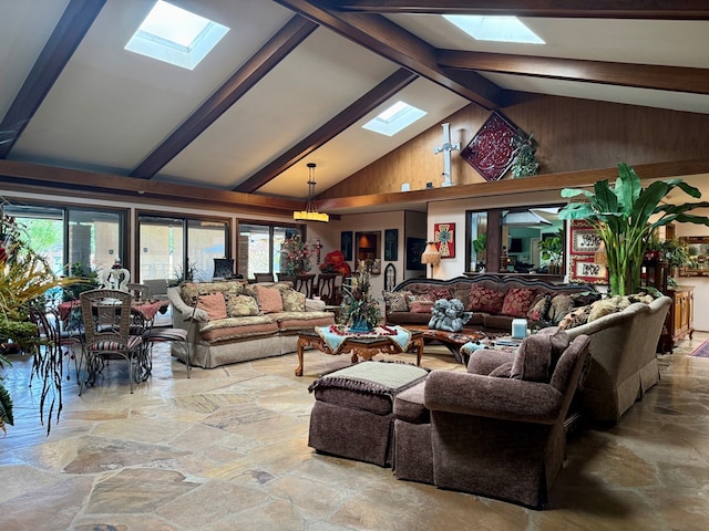 2500 Bainbridge Dr, Odessa, TX 79762 - living room featuring a skylight, stone flooring, healthy amount of natural light, beamed ceiling, and high vaulted ceiling