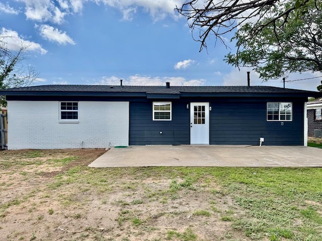 2816 Catalina Dr, Odessa, TX 79764 - back of property with a patio, brick siding, and a lawn