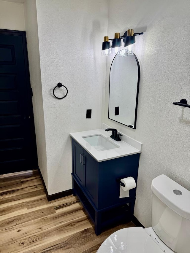 2816 Catalina Dr, Odessa, TX 79764 - bathroom with vanity, wood finished floors, and a textured wall