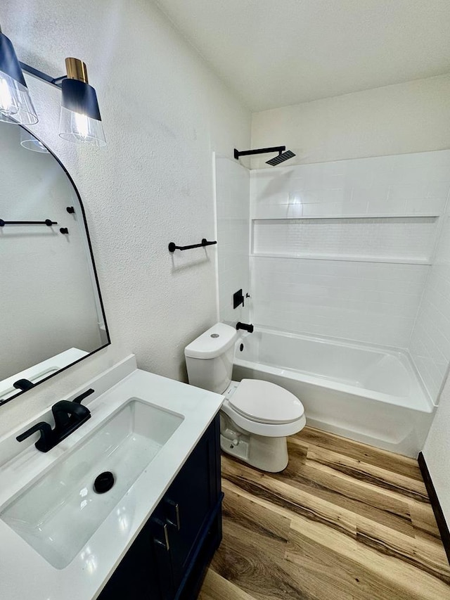 2816 Catalina Dr, Odessa, TX 79764 - bathroom with wood finished floors, a textured wall, vanity, and bathtub / shower combination