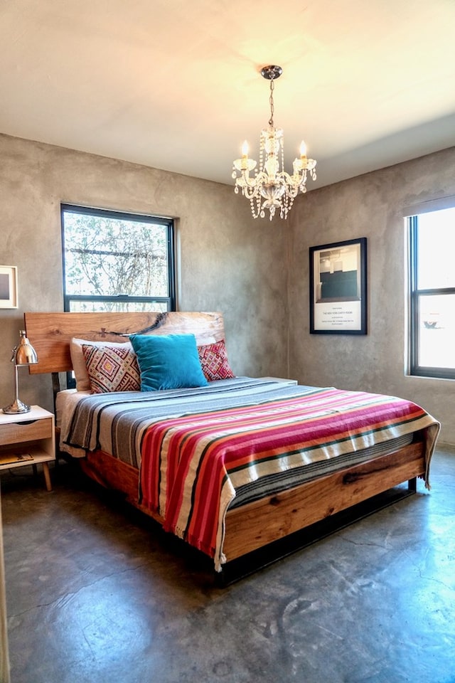 1109 E Murphy St, Marfa, TX 79843 - bedroom featuring a chandelier and finished concrete flooring