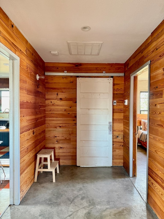 1109 E Murphy St, Marfa, TX 79843 - unfurnished bedroom featuring wood walls and unfinished concrete flooring