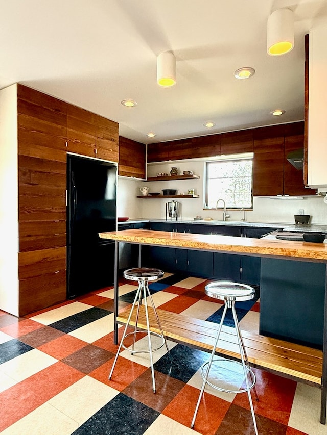 1109 E Murphy St, Marfa, TX 79843 - kitchen with open shelves, freestanding refrigerator, light countertops, recessed lighting, and light flooring