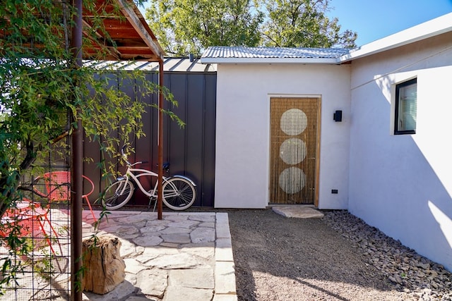 1109 E Murphy St, Marfa, TX 79843 - property entrance with stucco siding and a gate