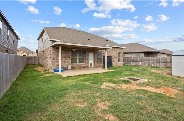 7012 Perot Ranch Rd, Odessa, TX 79765 - rear view of house with brick siding, a patio area, and roof with shingles